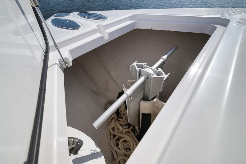 Slide: The Image of Anchor storage compartment on a 2020 Bahama 41 boat, featuring ropes and anchor mechanism. - 52