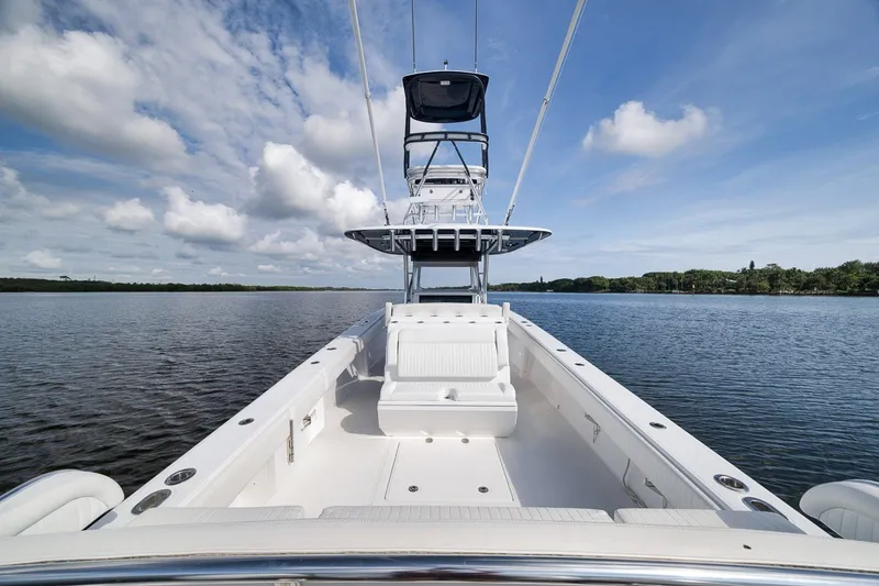 Slide: The Image of 2020 Bahama 41 boat on calm water under a blue sky with clouds. - 54