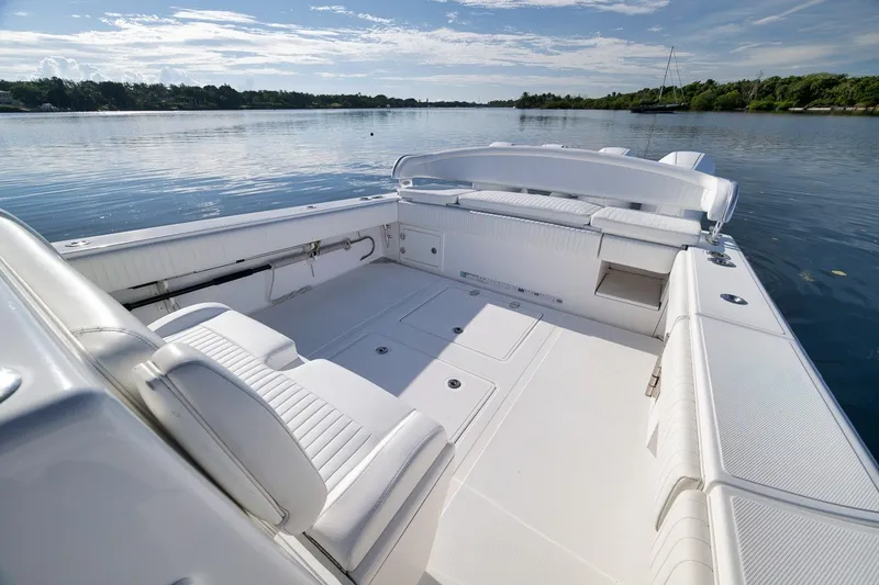 Slide: The Image of Luxurious 2020 Bahama 41 boat interior with white seating, docked on calm waters. - 37