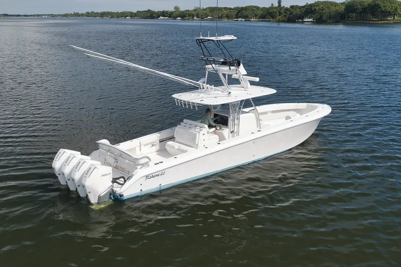 Slide: The Image of 2020 Bahama 41 boat with triple outboard engines on calm water. - 3