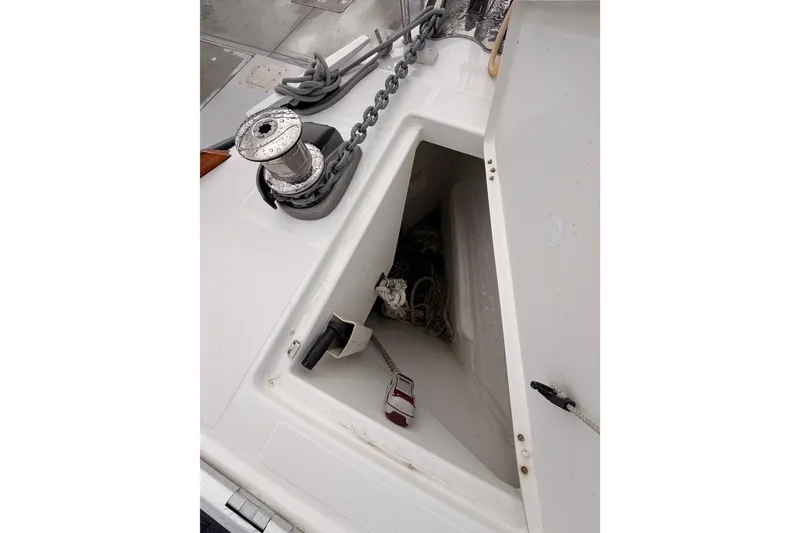 Slide: The Image of Anchor locker of 2015 Jeanneau Sun Odyssey 469 sailboat with chain and winch. - 16