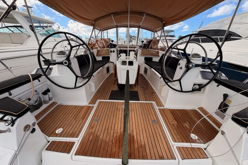 Slide: The Image of Cockpit of 2015 Jeanneau Sun Odyssey 469 sailboat with dual steering wheels and teak flooring. - 25