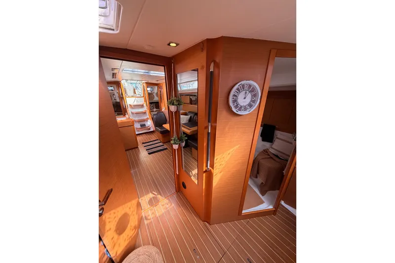 Slide: The Image of Interior of 2015 Jeanneau Sun Odyssey 469 yacht, featuring wood paneling and cozy cabin spaces. - 67