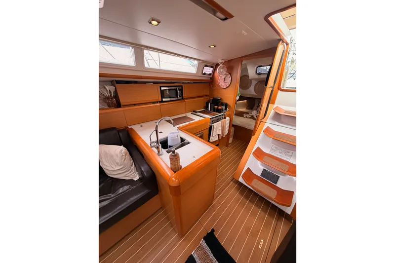 Slide: The Image of Interior of 2015 Jeanneau Sun Odyssey 469 yacht with modern kitchen and cozy seating area. - 40