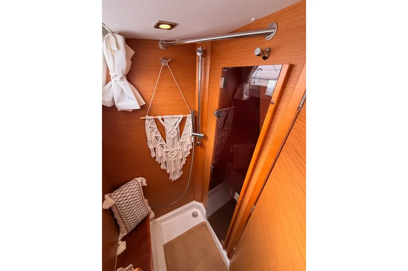 Slide: The Image of Cozy bathroom interior of 2015 Jeanneau Sun Odyssey 469 yacht with wooden accents. - 49