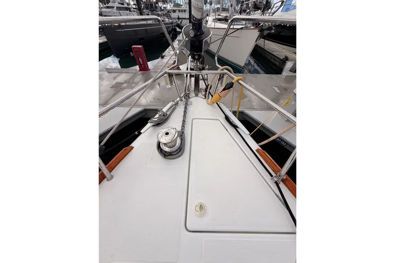 Slide: The Image of 2015 Jeanneau Sun Odyssey 469 yacht deck with winch and ropes in marina. - 15