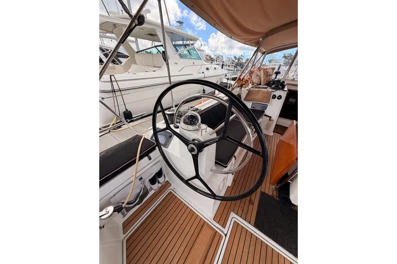 Slide: The Image of Steering wheel of a 2015 Jeanneau Sun Odyssey 469 sailboat, docked at a marina. - 33