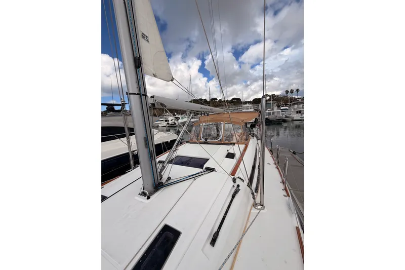 Slide: The Image of 2015 Jeanneau Sun Odyssey 469 sailboat docked in a marina under cloudy skies. - 18