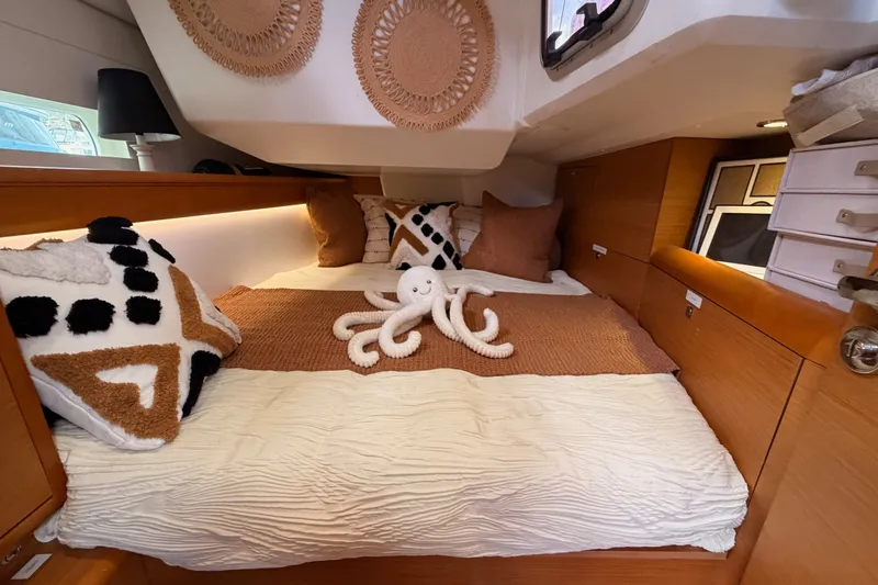 Slide: The Image of Cozy cabin interior of 2015 Jeanneau Sun Odyssey 469 with plush bedding and decorative pillows. - 44