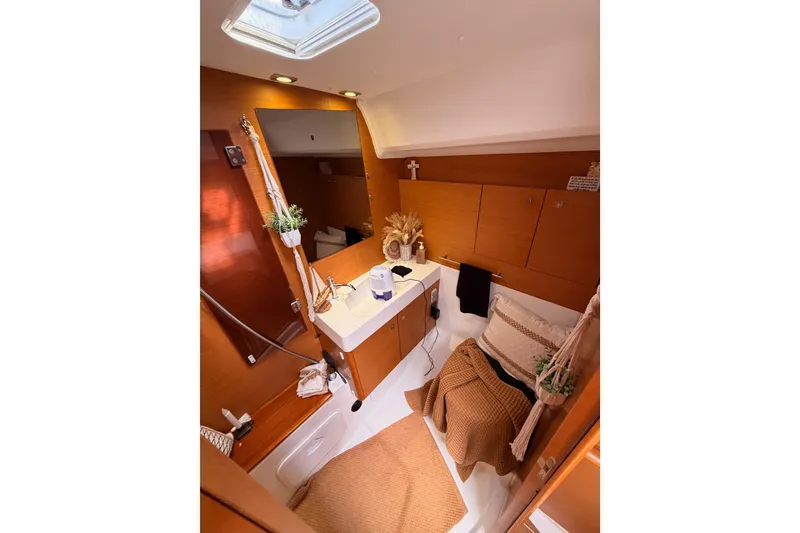 Slide: The Image of Interior of 2015 Jeanneau Sun Odyssey 469 yacht, featuring a cozy cabin with wooden finishes. - 63
