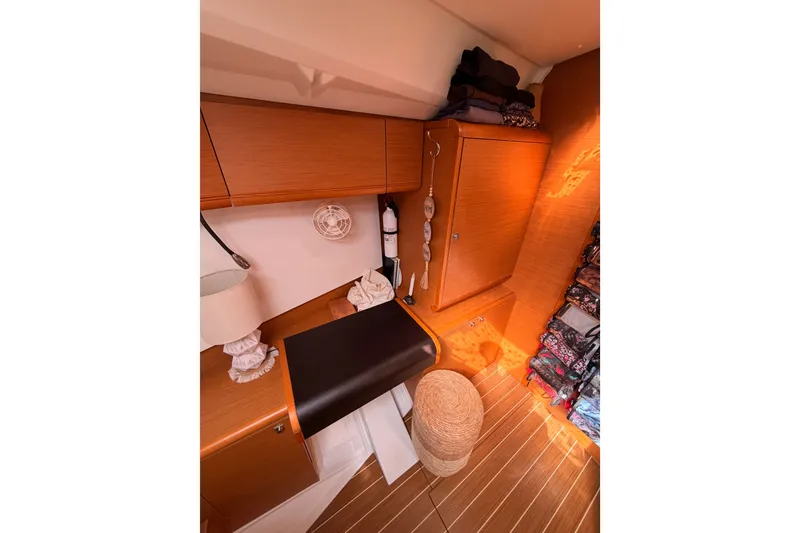 Slide: The Image of Interior of 2015 Jeanneau Sun Odyssey 469 yacht with wooden cabinetry and organized storage. - 66