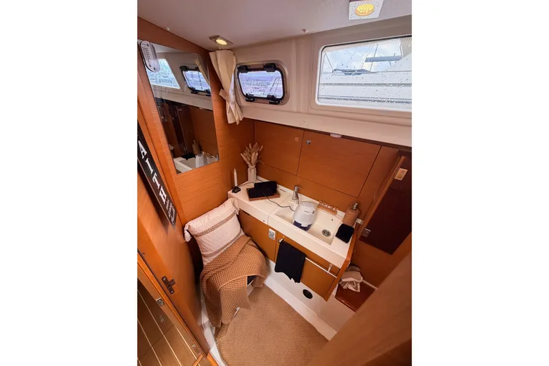 Slide: The Image of Interior of 2015 Jeanneau Sun Odyssey 469 yacht bathroom with wooden cabinetry and sink. - 47