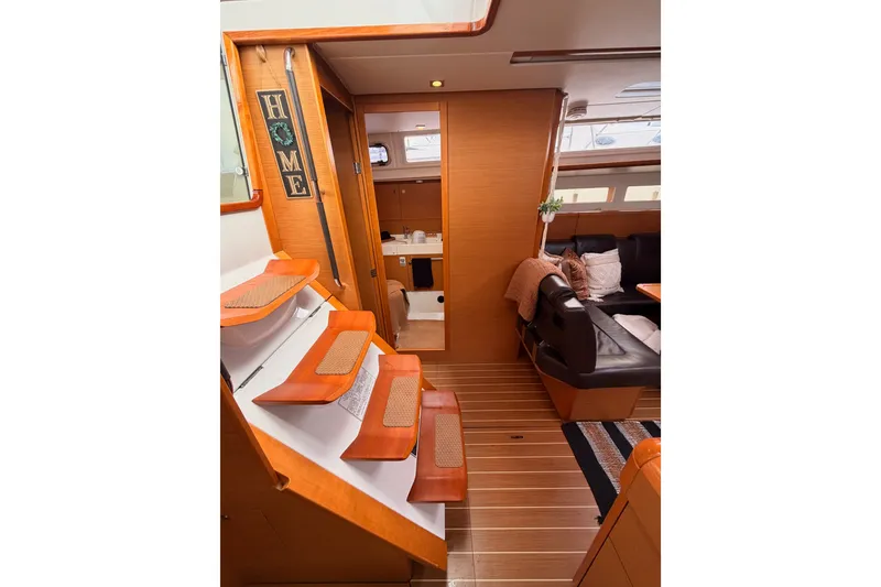 Slide: The Image of Interior of 2015 Jeanneau Sun Odyssey 469 yacht, featuring cozy seating and wooden finishes. - 46