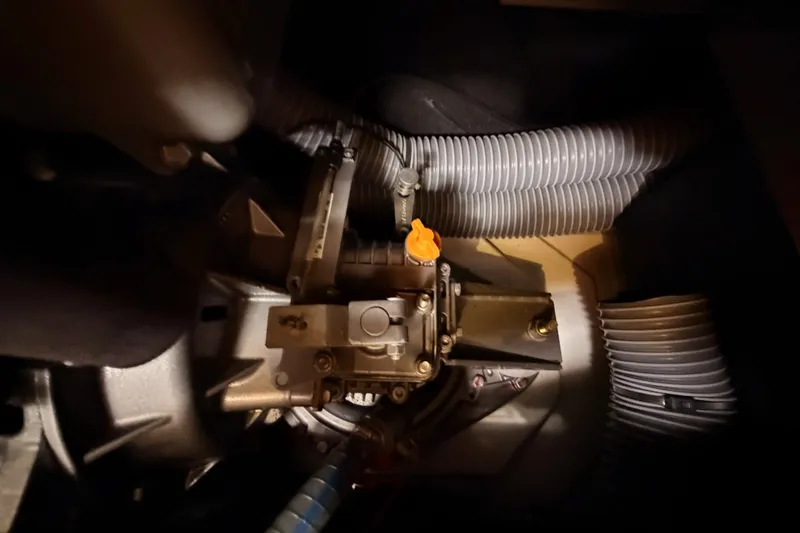 Slide: The Image of Engine compartment of a 2015 Jeanneau Sun Odyssey 469 sailboat, featuring mechanical components and hoses. - 75