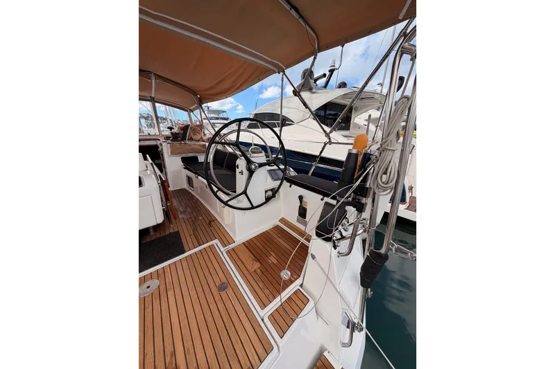 Slide: The Image of Cockpit of 2015 Jeanneau Sun Odyssey 469 sailboat with wooden deck and steering wheel. - 26