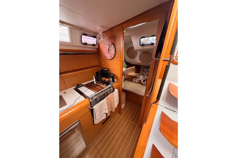 Slide: The Image of Interior of 2015 Jeanneau Sun Odyssey 469 yacht, featuring cozy cabin and modern kitchen amenities. - 42