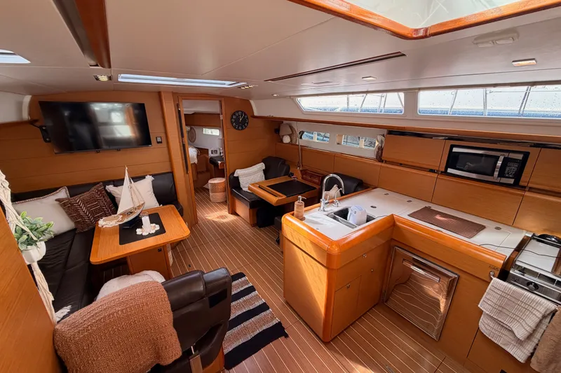 Slide: The Image of Luxurious interior of 2015 Jeanneau Sun Odyssey 469 yacht with modern kitchen and seating area. - 52