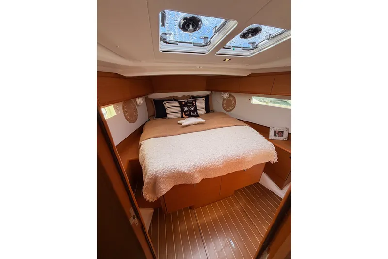 Slide: The Image of Cozy cabin interior of 2015 Jeanneau Sun Odyssey 469 sailboat with skylights and plush bedding. - 65