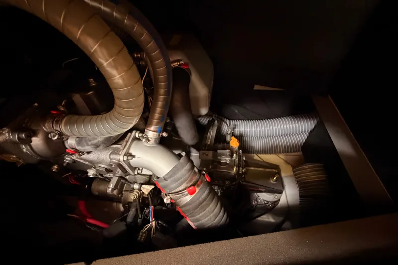 Slide: The Image of Engine compartment of a 2015 Jeanneau Sun Odyssey 469 sailboat, showcasing hoses and components. - 74