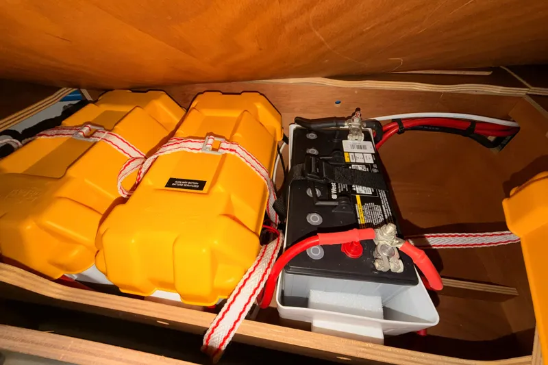 Slide: The Image of Battery compartment of 2015 Jeanneau Sun Odyssey 469 with secured yellow battery boxes. - 77