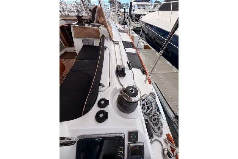 Slide: The Image of 2015 Jeanneau Sun Odyssey 469 yacht deck with winch and ropes in marina. - 31