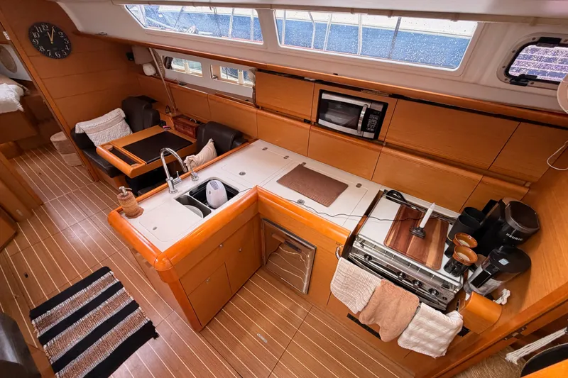 Slide: The Image of 2015 Jeanneau Sun Odyssey 469 interior with modern kitchen and dining area. - 39