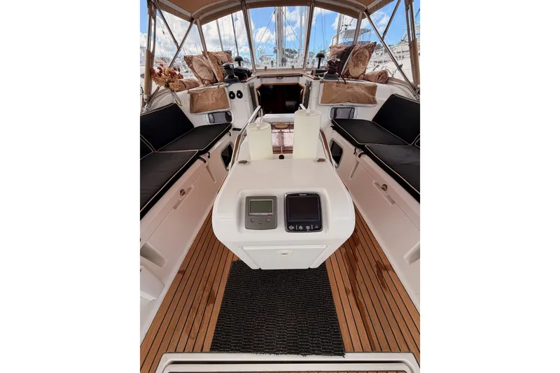 Slide: The Image of Cockpit of 2015 Jeanneau Sun Odyssey 469 sailboat with teak flooring and cushioned seating. - 32