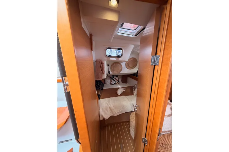 Slide: The Image of Cozy cabin interior of 2015 Jeanneau Sun Odyssey 469 sailboat with wooden finish. - 50