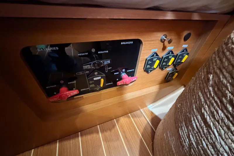 Slide: The Image of Electrical panel on a 2015 Jeanneau Sun Odyssey 469 sailboat, featuring battery switches and breakers. - 79