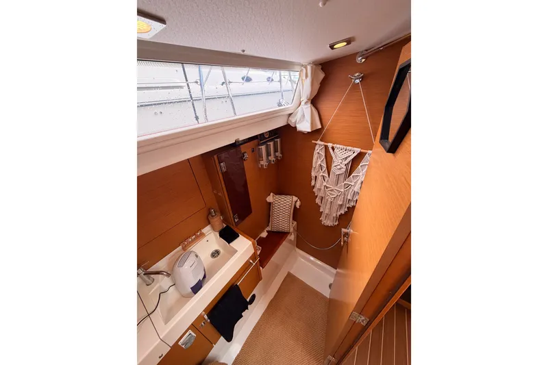 Slide: The Image of Interior of 2015 Jeanneau Sun Odyssey 469 yacht bathroom with sink and window. - 48