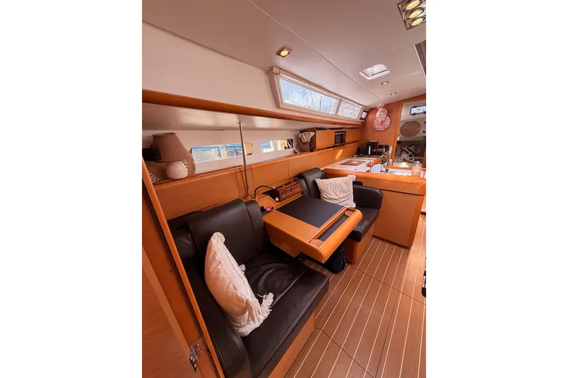Slide: The Image of Interior of 2015 Jeanneau Sun Odyssey 469 yacht with cozy seating and wooden finishes. - 68