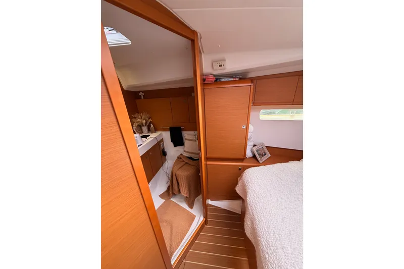 Slide: The Image of Interior of 2015 Jeanneau Sun Odyssey 469 yacht, featuring cozy cabin and wooden finishes. - 62