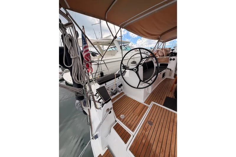 Slide: The Image of 2015 Jeanneau Sun Odyssey 469 sailboat cockpit with wooden deck and steering wheel. - 27