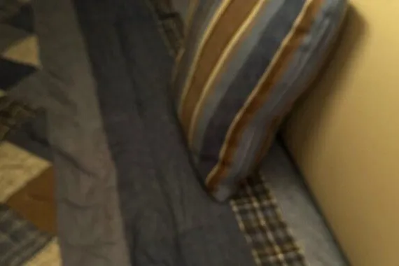 Slide: The Image of Cozy interior of 2004 Bayliner 285 Cruiser with striped pillow and patchwork quilt. - 7
