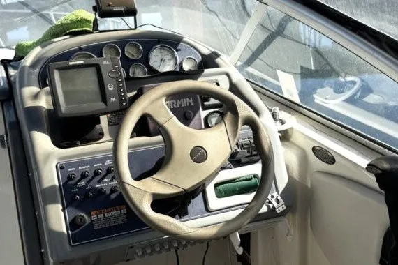 Slide: The Image of 2004 Bayliner 285 Cruiser dashboard with steering wheel and navigation instruments. - 5