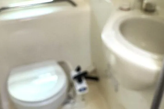 Slide: The Image of 2004 Bayliner 285 Cruiser bathroom with toilet and sink. - 8