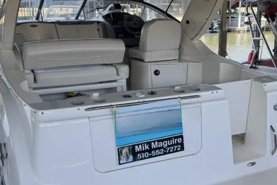 Slide: The Image of 2004 Bayliner 285 Cruiser boat interior with seating and control panel, docked at marina. - 3