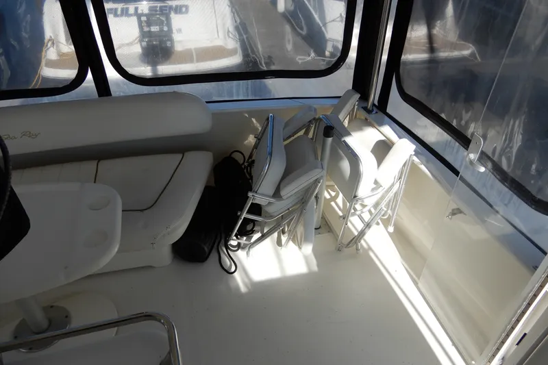 Slide: The Image of Interior of 2000 Sea Ray 380 Aft Cabin with seating and folded chairs. - 16