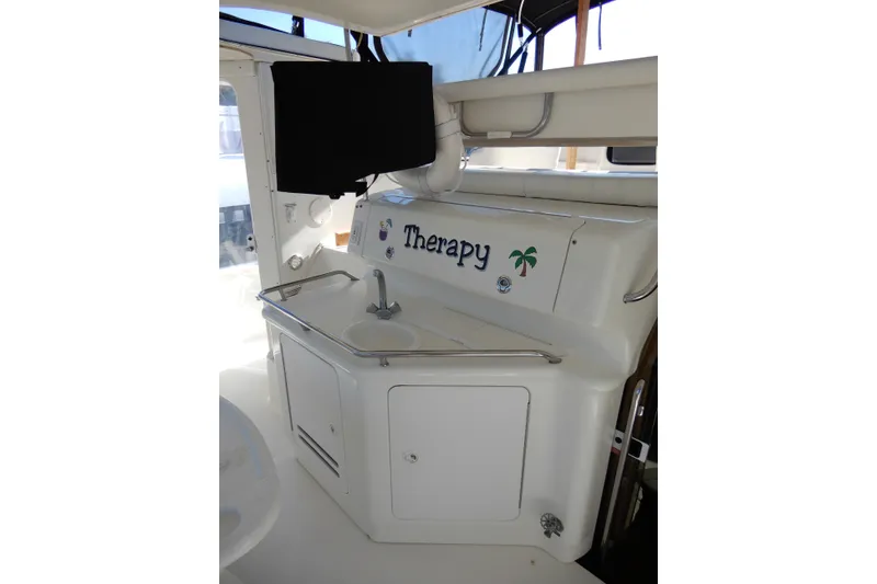Slide: The Image of 2000 Sea Ray 380 Aft Cabin yacht interior with sink and "Therapy" decal. - 17