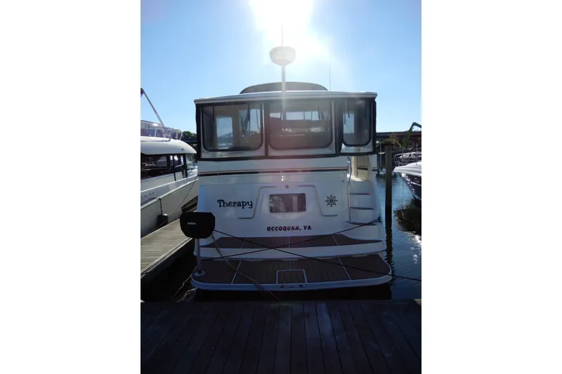 Slide: The Image of Sea Ray 380 Aft Cabin 2000 docked, rear view with sunlight above. - 4