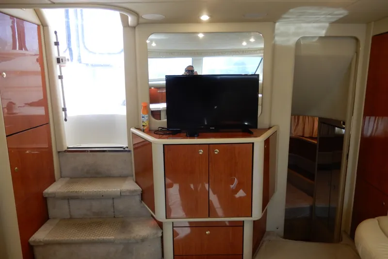 Slide: The Image of Interior of 2000 Sea Ray 380 Aft Cabin with TV and wooden cabinetry. - 46