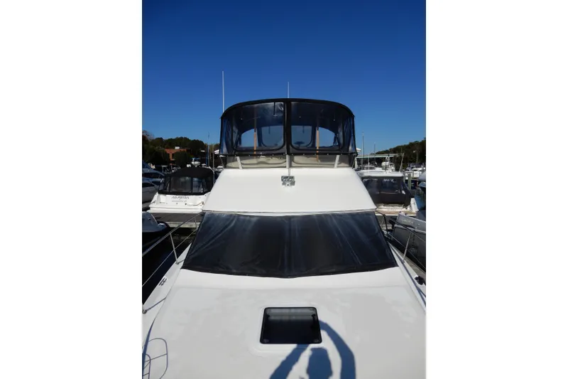 Slide: The Image of Sea Ray 380 Aft Cabin 2000 yacht docked under clear blue sky. - 36