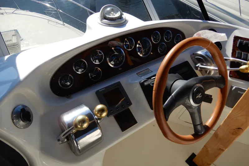 Slide: The Image of Steering wheel and controls of a 2000 Sea Ray 380 Aft Cabin yacht. - 26