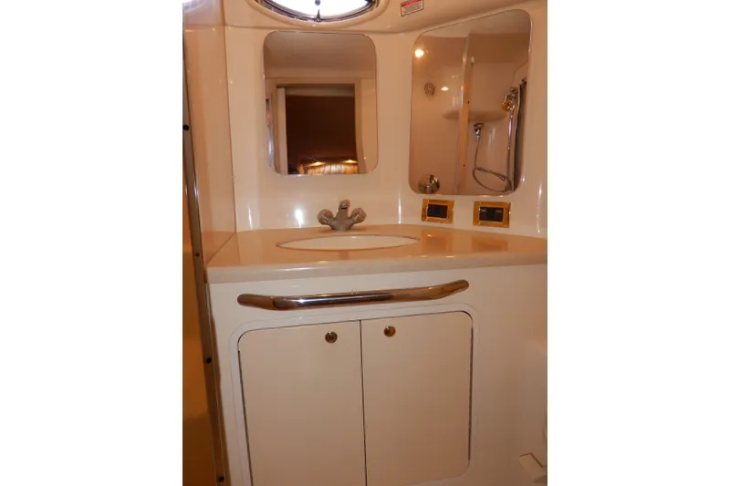 Slide: The Image of Bathroom vanity in 2000 Sea Ray 380 Aft Cabin yacht, featuring sink and mirror. - 74
