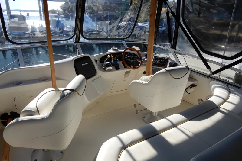Slide: The Image of Interior view of 2000 Sea Ray 380 Aft Cabin yacht cockpit with white seating. - 20