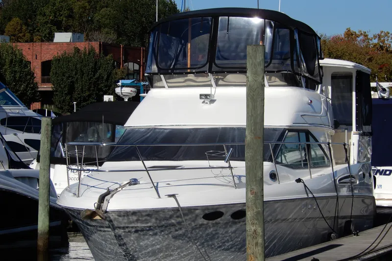 Slide: The Image of 2000 Sea Ray 380 Aft Cabin yacht docked at marina, surrounded by other boats. - 2