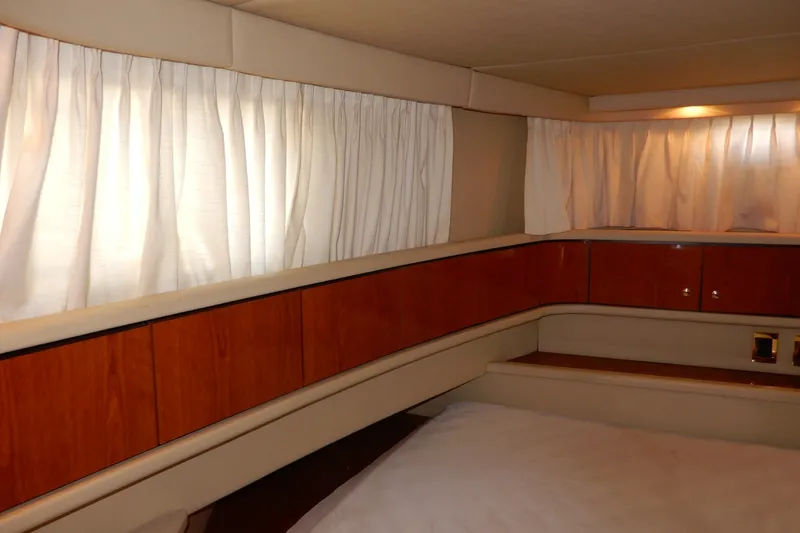 Slide: The Image of Interior cabin of 2000 Sea Ray 380 Aft Cabin yacht with wood paneling and curtains. - 70