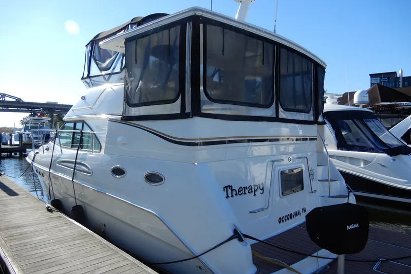 Slide: The Image of 2000 Sea Ray 380 Aft Cabin yacht docked at marina, rear view. - 6