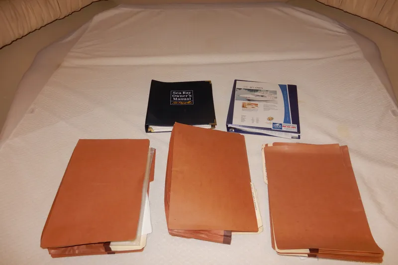 Slide: The Image of Sea Ray 380 Aft Cabin 2000 manuals and documents on a table. - 63