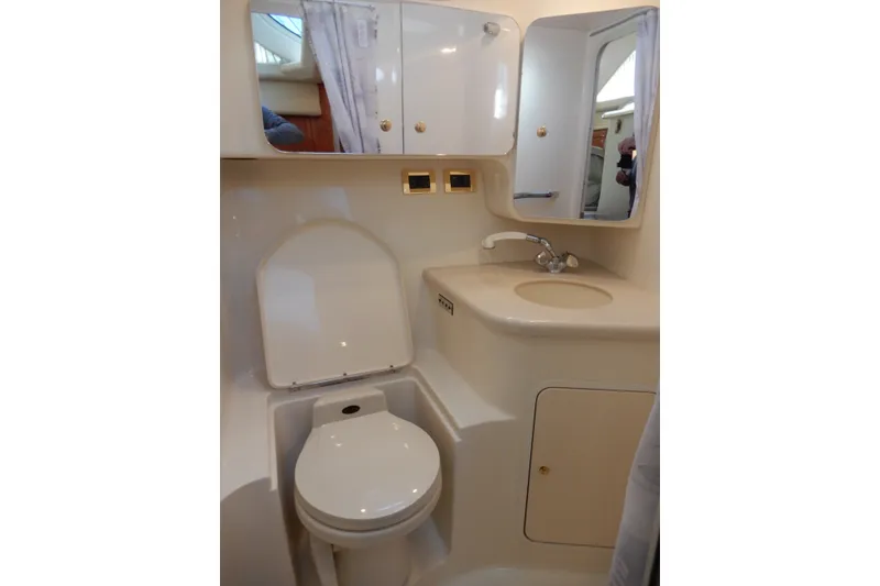 Slide: The Image of Bathroom interior of 2000 Sea Ray 380 Aft Cabin yacht, featuring toilet and sink. - 57